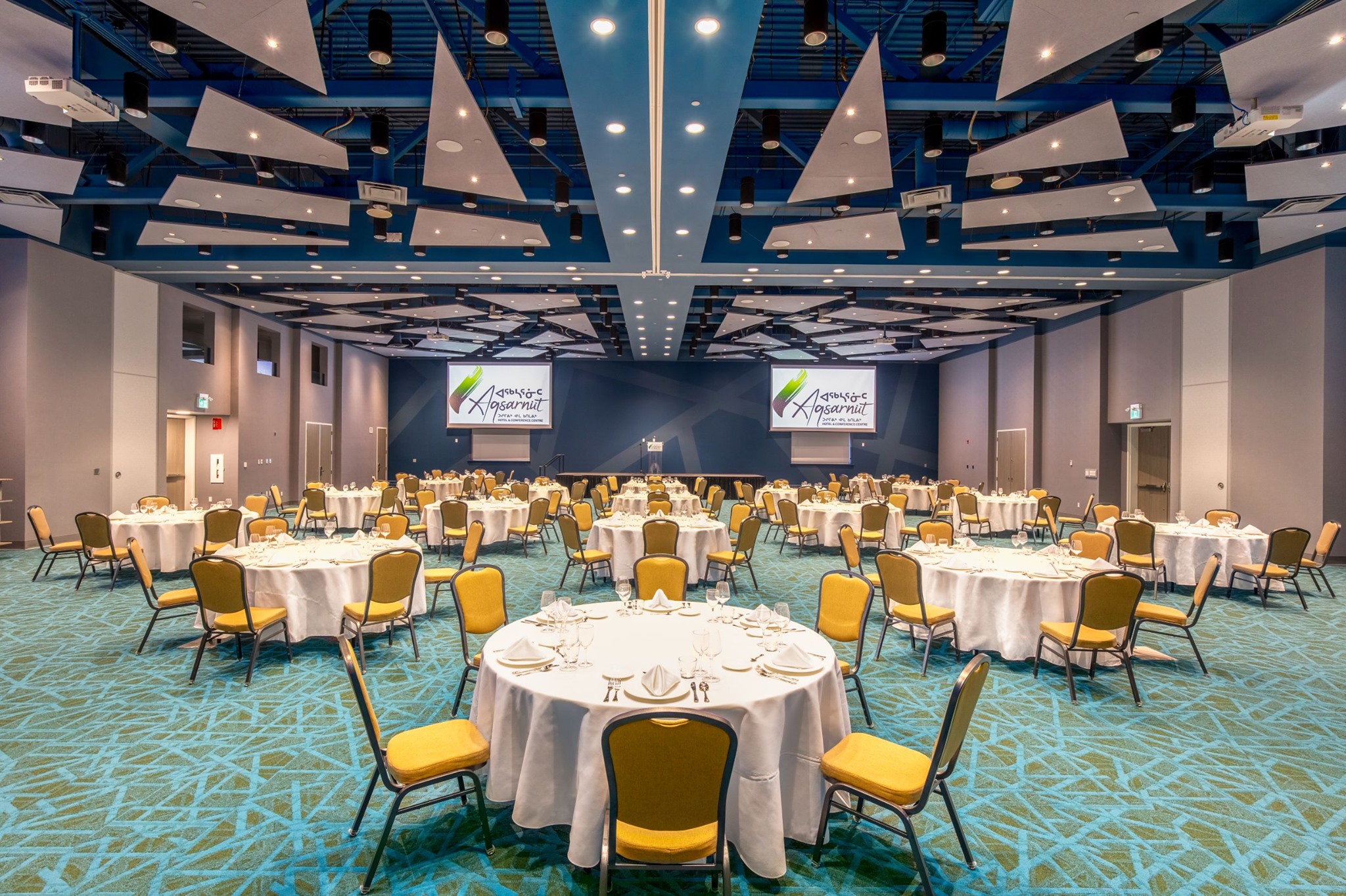 Interior of conference room with shapes on carpet and video screens